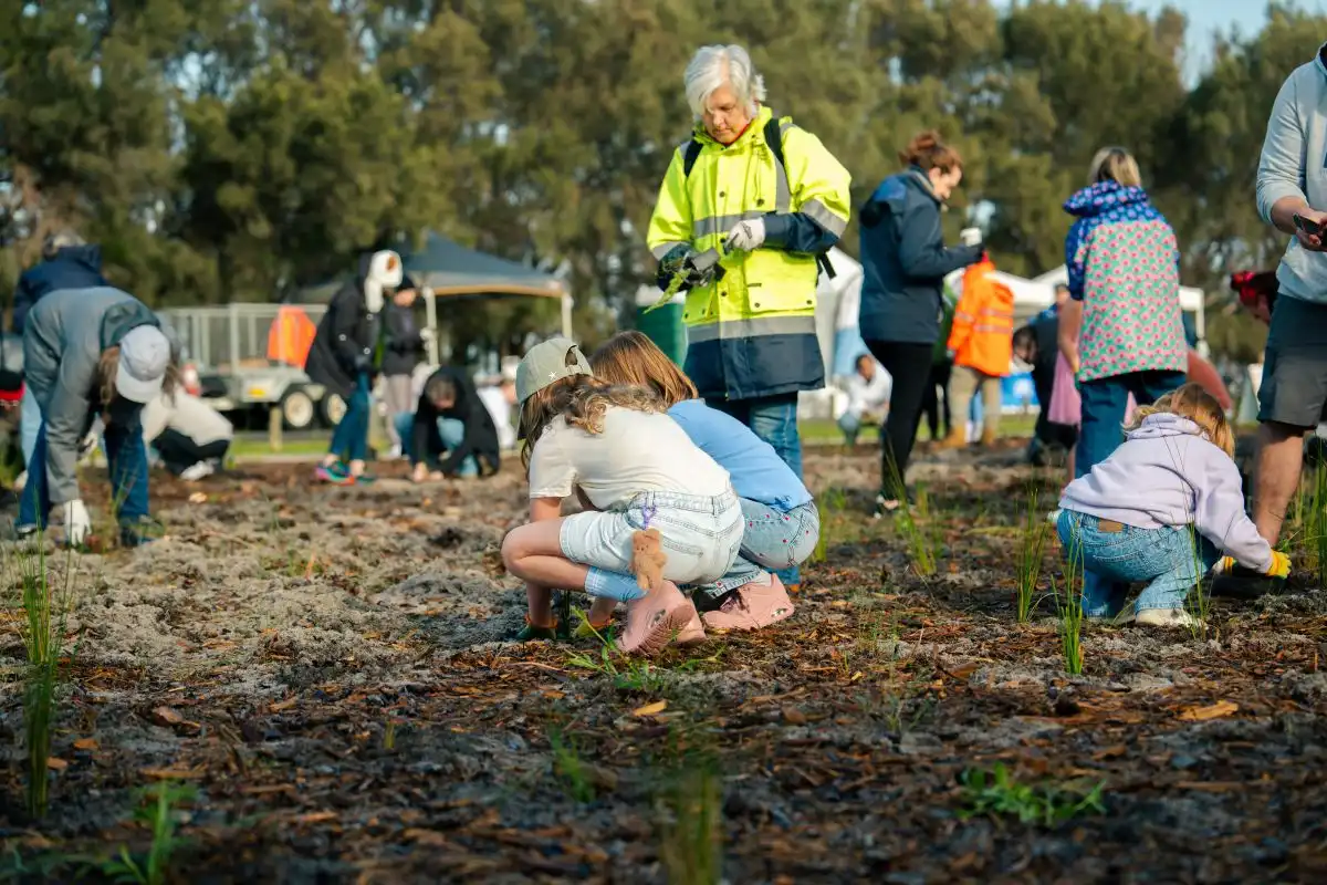 Two girls planting seedlings at National Tree Day